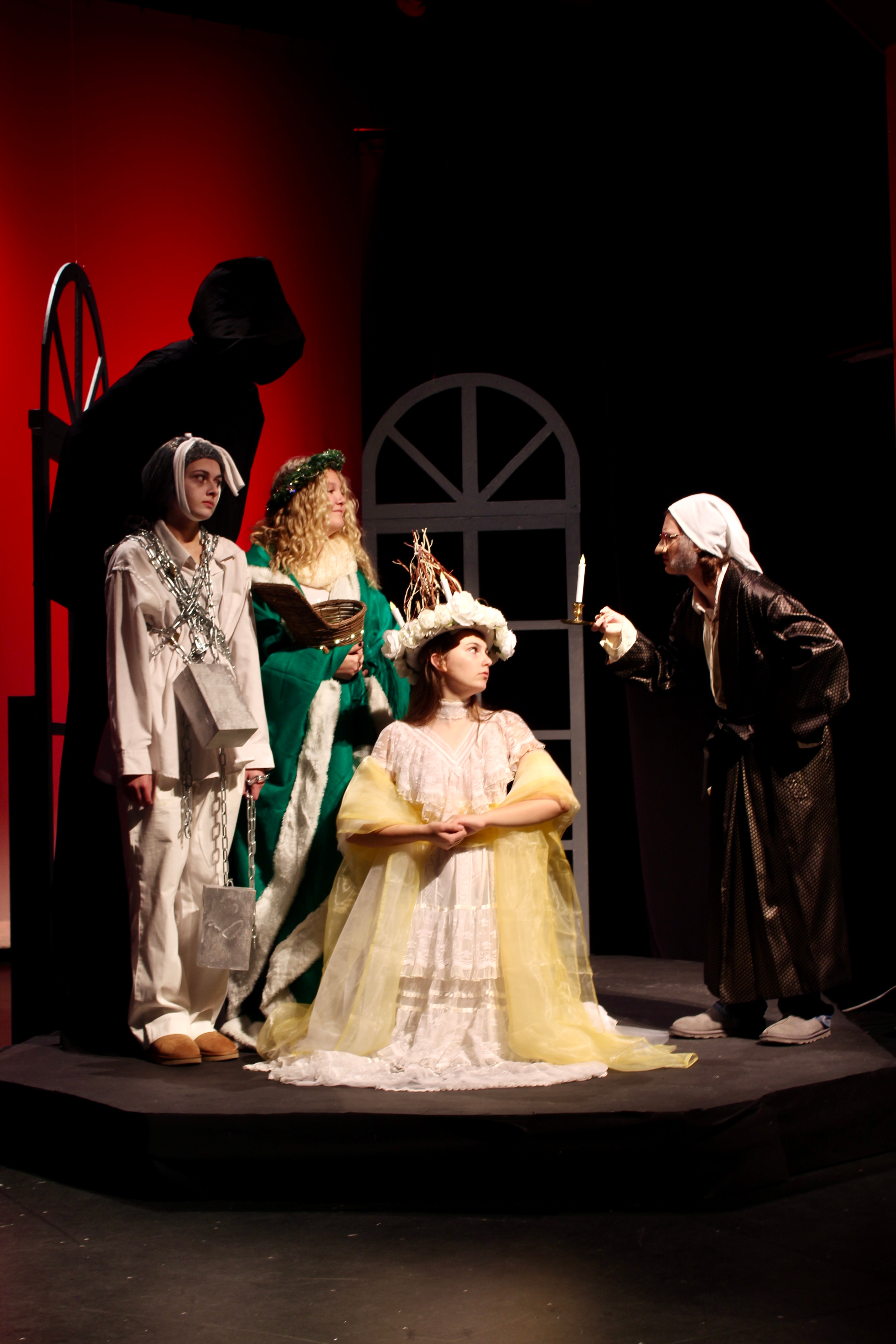 In the photo are Sara Giddens as Scrooge, Amelia Connor as Christmas Past, Kayana Jacobson-Theriault as Christmas Present, Camryn Chase as Marley and Abraham Medrano as Christmas Future.   